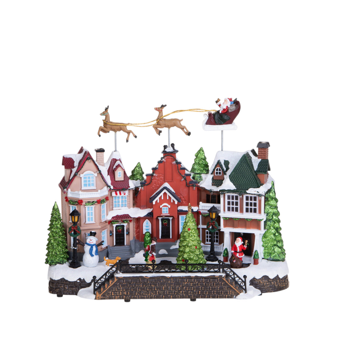 Villaggio con slitta movimento+luci+musica • H 33 cm
