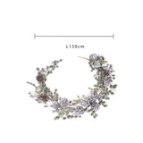 Ghrilanda con pigne e neve • H 11 cm