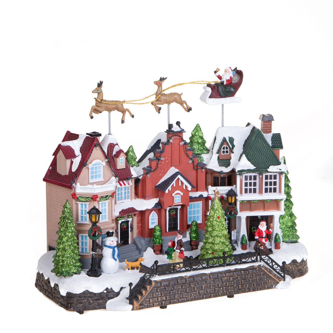 Villaggio con slitta movimento+luci+musica • H 33 cm